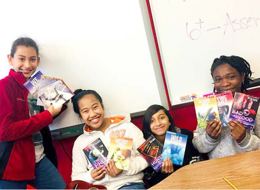 students happily holding books